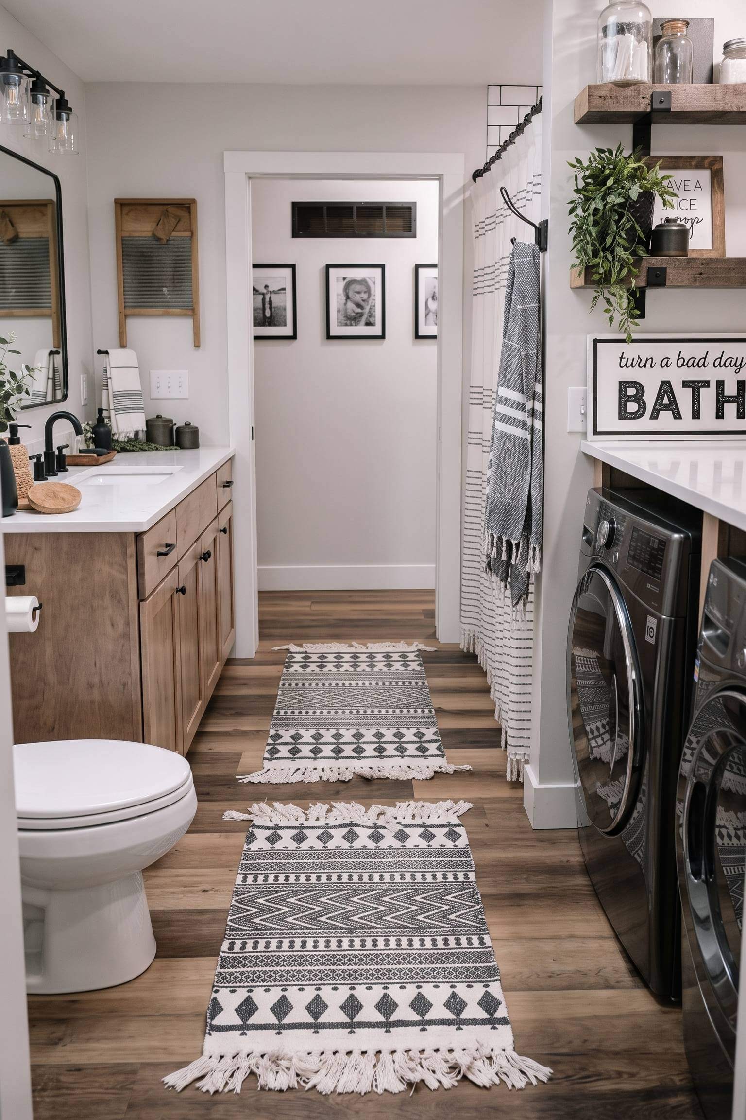 A cozy bohemian laundry room bathroom combo featuring patterned black and white runner rugs and floating wood shelves.